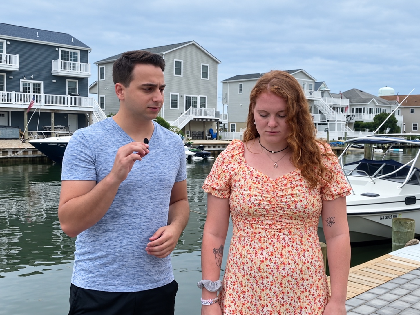 Tyler guiding a waterfront demonstration beside a participant with eyes closed and head slightly lowered.